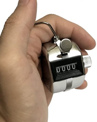 metal plated push activated tally counter held in hand